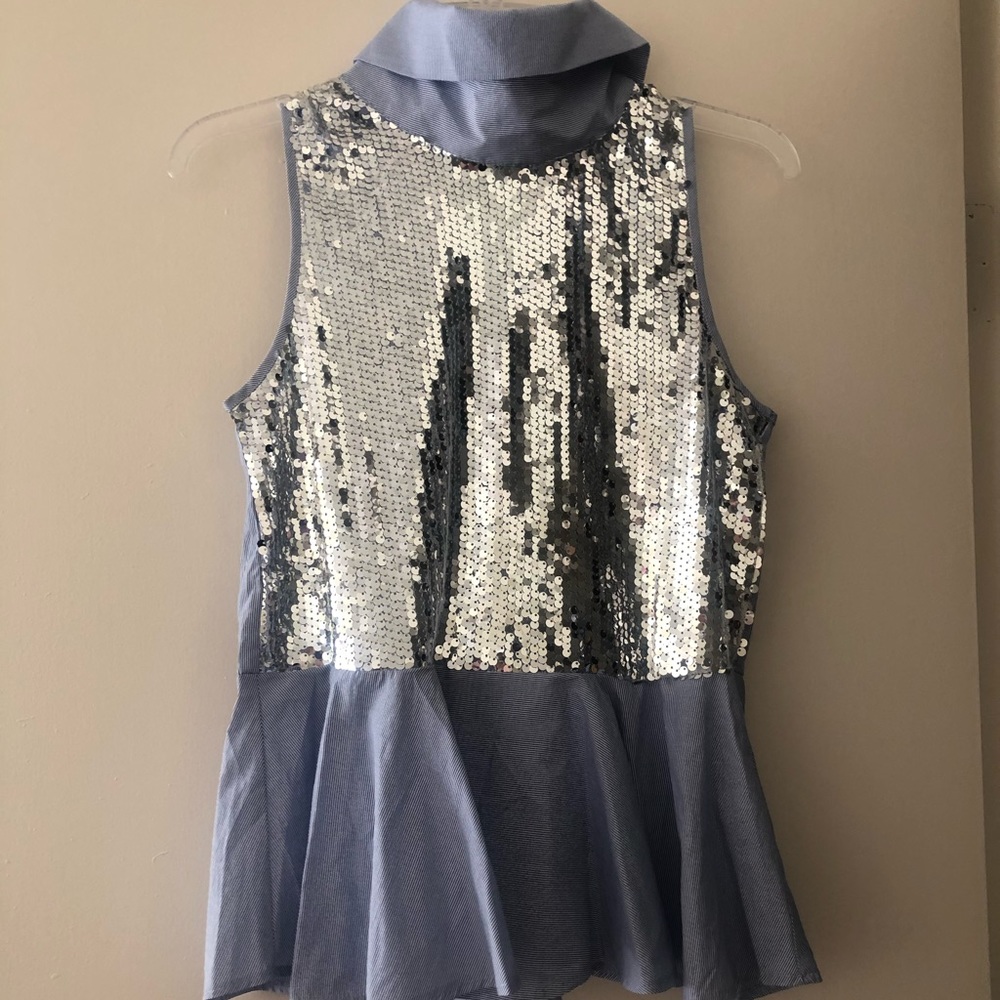 Sleeveless high neck sequined top.